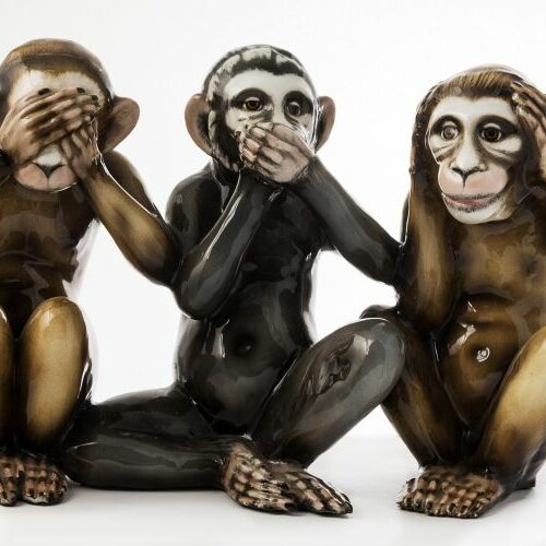 Gruppo in porcellana raffigurante tre scimmiette "non vedo, non parlo, non sento". Cacciapuoti. Epoca anni '50.